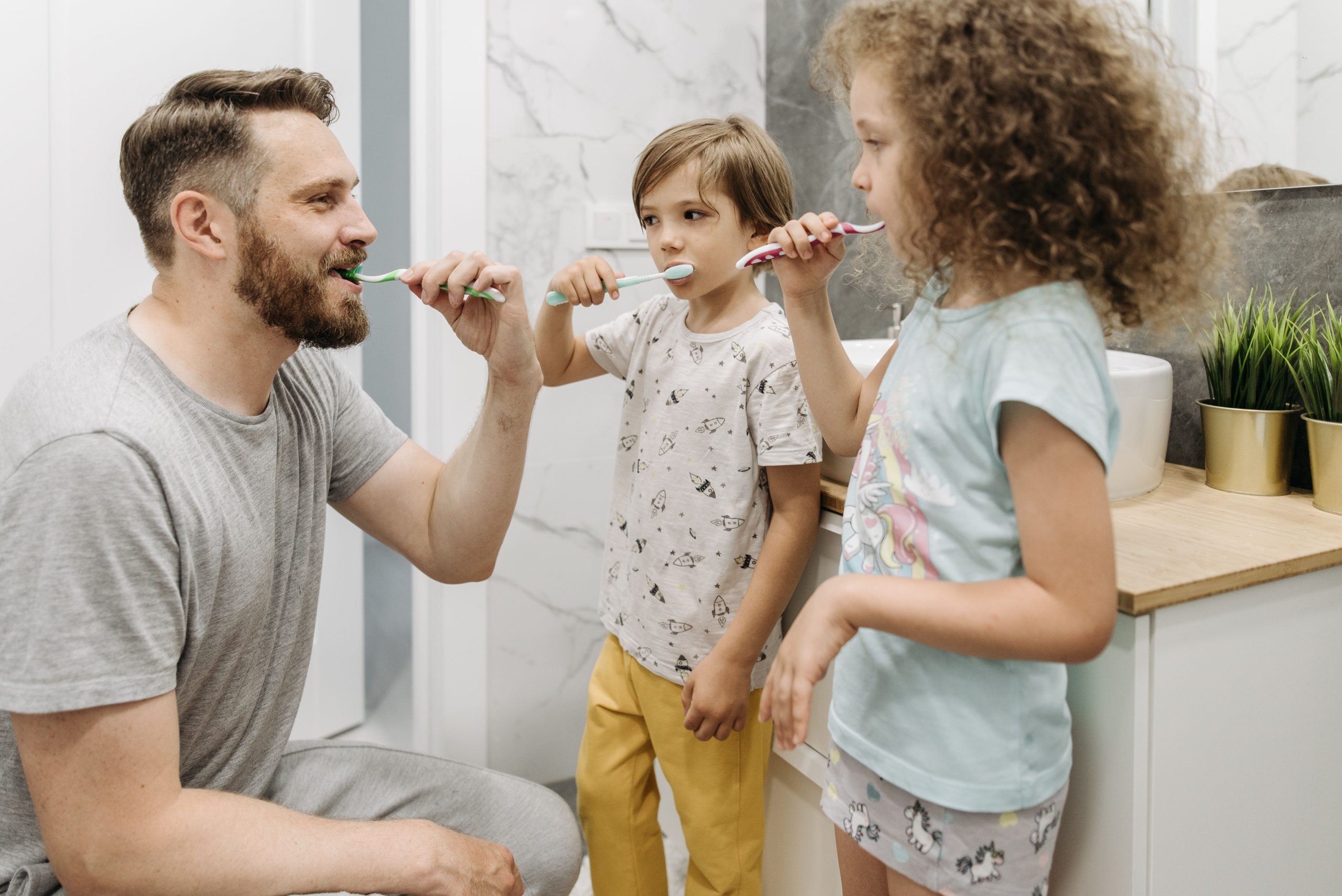 family brushing teeth